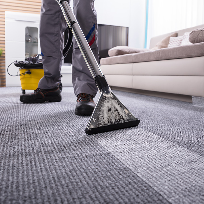 man with a vacuum cleaning a carpet meridian id